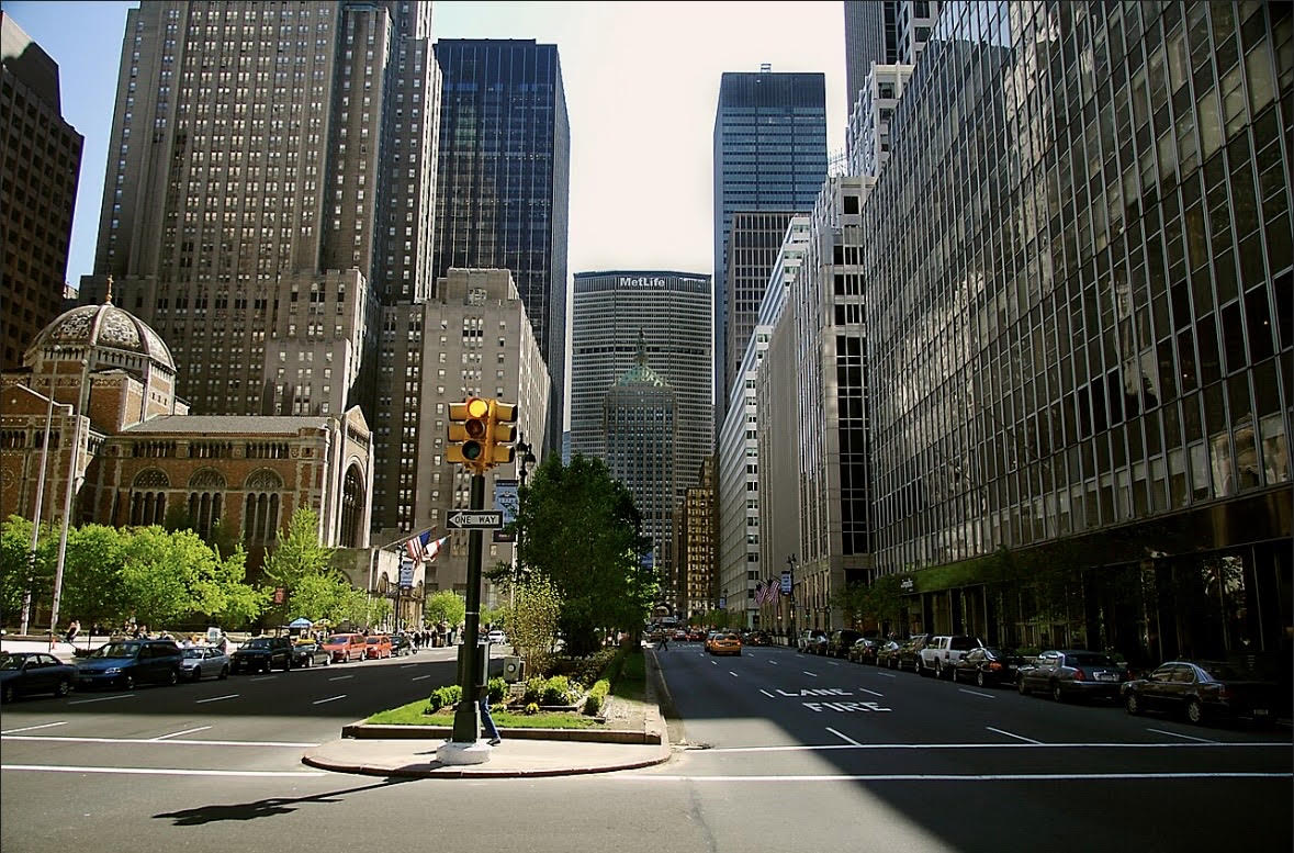 A wide Upper East Side avenue looking south toward midtown towers