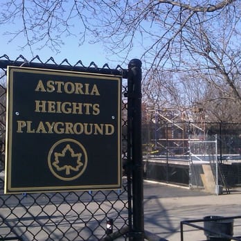 The Astoria Heights Playground sign on the park fence