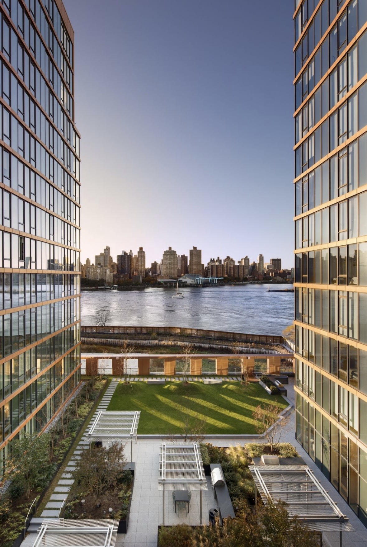 Waterfront courtyard between residential towers at Hallets Point, looking across the East River